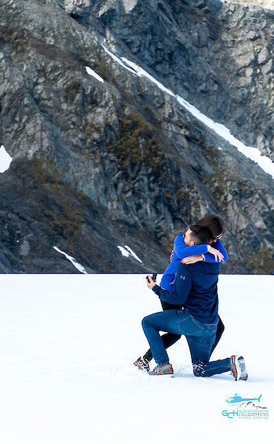 Couple getting engaged on the glacier Franz Josef.