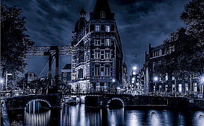 Amsterdam at night glows just as much in North Holland, the Netherlands. Flickr:Elyktra