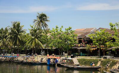 Boats and palm trees along the river in Hoi An, Vietnam. Unsplash:Aiph Doan