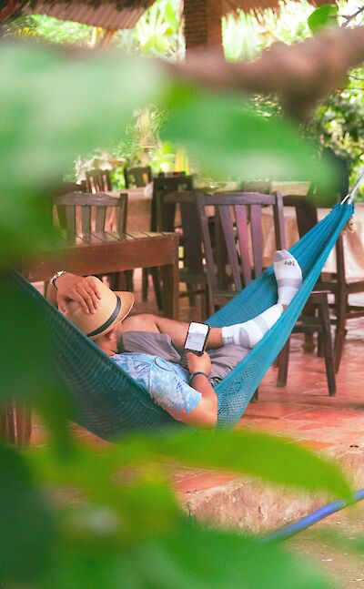 Lying in a hammock in the Mekong Delta, Vietnam. Unsplash:Jewad Alnabi