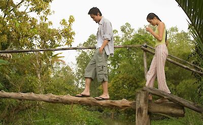 Walking a bridge over the Mekong Delta, Vietnam. Unsplash:Getty Images