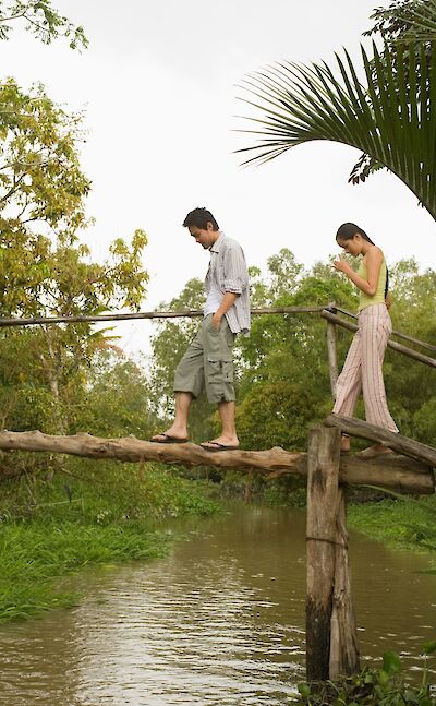 Walking a bridge over the Mekong Delta, Vietnam. Unsplash:Getty Images