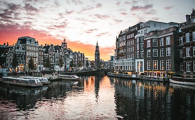 Amsterdam at sunset, Netherlands. Unsplash: Max Van Den Oetelaar