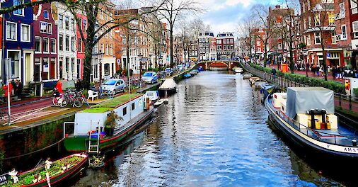 Colorful boats along the canal. Unsplash: Massimo Virgilio