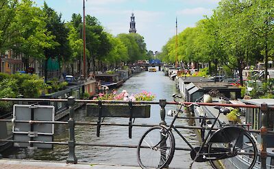 Bicycle parked on a bridge in Amsterdam, Netherlands. Unsplash: Callum Parker