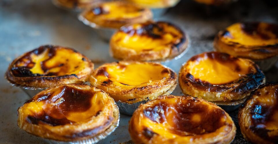 Fresh pasteis de nata, Portugal. Unsplash: Nick Fewings