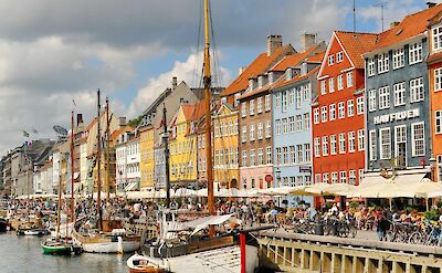 Biking through Nyhavn ("New Harbor") in Copenhagen, Denmark. Flickr:Dimitris Karagiorgos