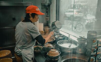 Masterful food preparation in Chinatown Restaurant, New York, USA. Unsplash: Clay Banks