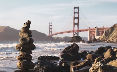 Stone tower with Golden Gate Bridge in background. Unsplash: Ryan Stone