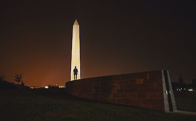 Man's silhouette in front of the Washington Monument at night, Washington DC, USA. Unsplash: Joshua Earle