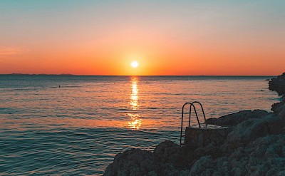 Sunset at a beach in Zadar, Croatia. Unsplash@Maxi Am Brunnen
