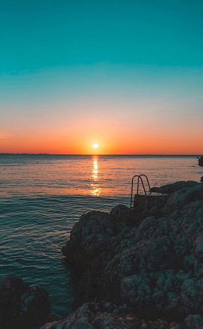 Sunset at a beach in Zadar, Croatia. Unsplash@Maxi Am Brunnen