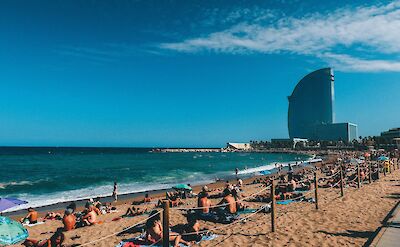Sun bathers on a Barcelona Beach, Barcelona, Spain. Unsplash: Marc Fanelli-Isla
