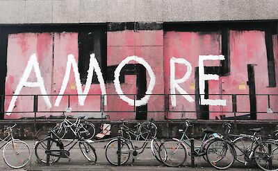 Bicycles in front of mural, Cologne, Germany. Unsplash: Abi Schreider