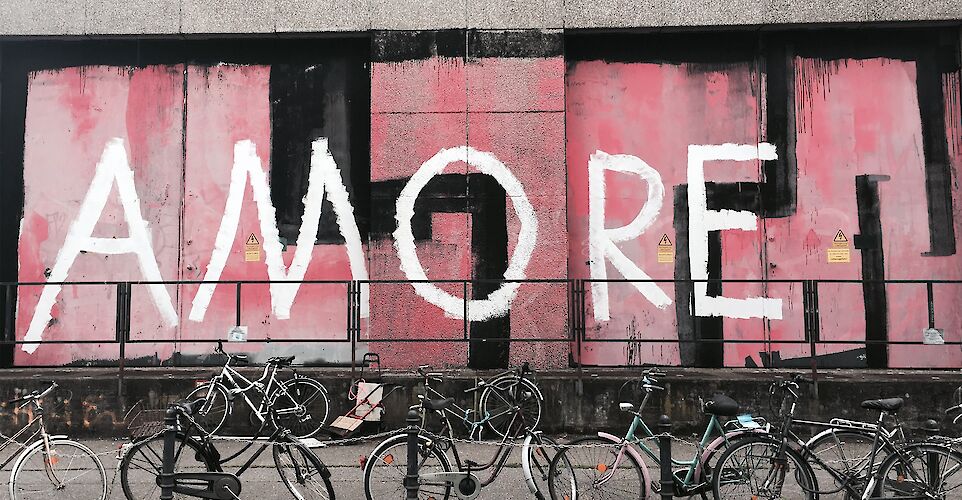 Bicycles in front of mural, Cologne, Germany. Unsplash: Abi Schreider