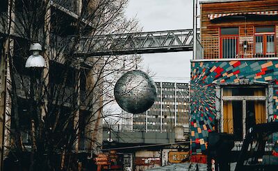 Large disco ball hangin in the streets, Berlin, Germany. Unsplash: Tiago Aleixo