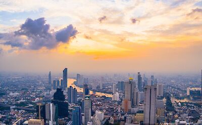 Orange skies over the Bangkok skyline at dusk, Bangkok, Thailand. Unsplash: Waranont (Joe)