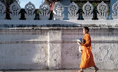 Monk walking in Chiang Mai, Thailand. Unsplash: Chris Arthur Collins