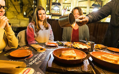 Pouring sauce on the dish, Porto, Portugal. CC: Eating Europe