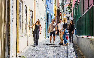 Looking at local art, Lisbon, Portugal. CC: Eating Europe