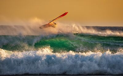 Surfing in Palaiochora, Crete, Greece. Unsplash:GEORGE DESIRPRIS