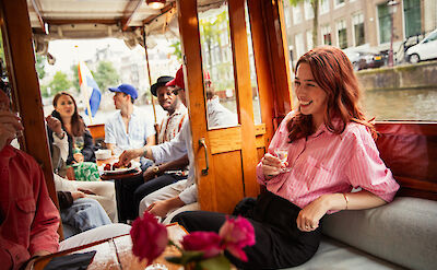 Enjoying drinks on the canal boat, Amsterdam, Netherlands. CC: Eating Europe