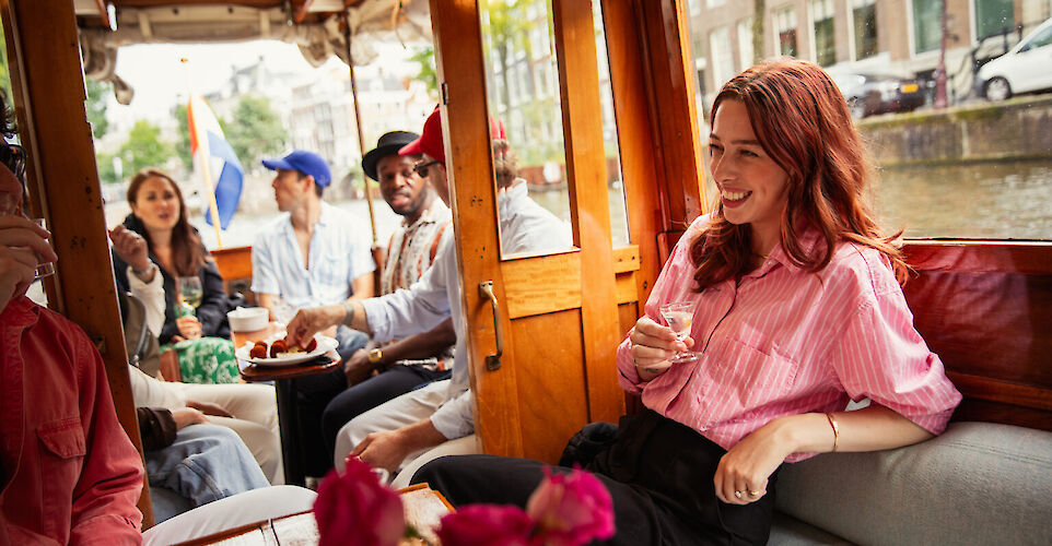 Enjoying drinks on the canal boat, Amsterdam, Netherlands. CC: Eating Europe