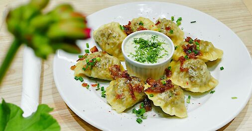 Pierogi with garnish, Warsaw, Poland. Unsplash: Eugen Kucheruk