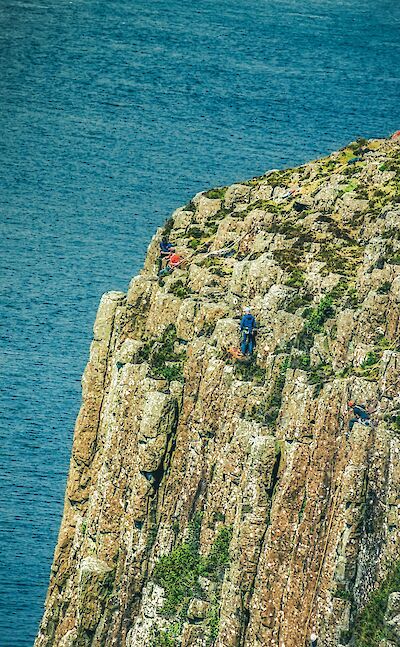 Climbers on the volcanic rock formations of Fair Head, County Antrim in Northern Ireland. Unsplash:K. Mitch Hodge
