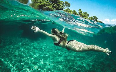 Swimming in the crystal clear sea. Unsplash: Adam Eperjesi