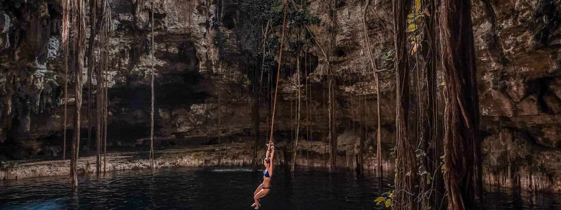 Swinging on a vine over a cenote, Mexico. Unsplash: The free birds