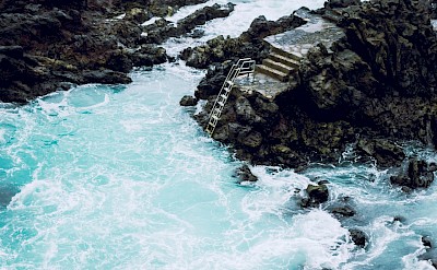 Ladder into a volcanic bathing pool, Tenerife, Spain. Unsplash@David Dvoracek