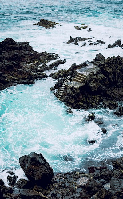 Ladder into a volcanic bathing pool, Tenerife, Spain. Unsplash@David Dvoracek