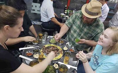 Trying BBQ meat, Seoul, South Korea.