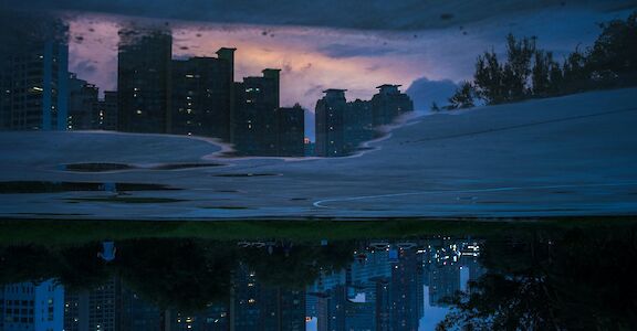 Seoul reflected in a puddle, South Korea. Unsplash: Soop Kim