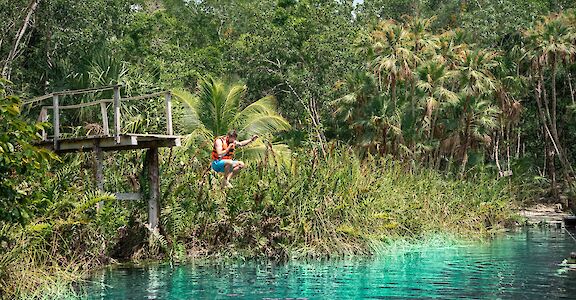 Jumping off a platform into a cenote, Tulum, Mexico. CC:Mexico Kan Tours