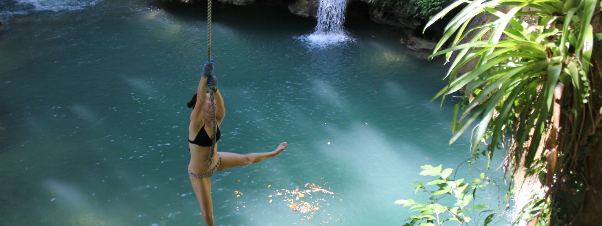 Swinging from a rope at YS Falls, Jamaica.