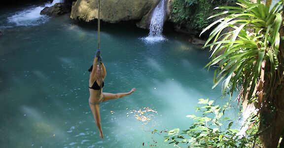 Swinging from a rope at YS Falls, Jamaica.