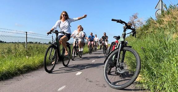 Group cycling past, Holland. CC:Mikes Bike Tours Amsterdam