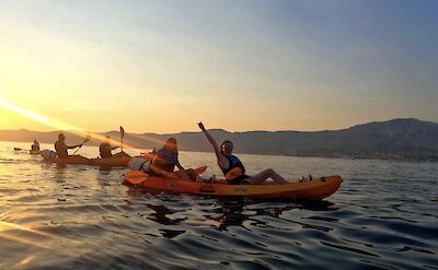 Friends enjoying a sunset kayaking tour, Split, Croatia. CC:Given2Fly Adventures