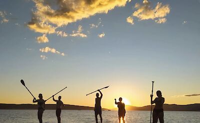 Group stand up paddleboarding at sunset, Split, Croatia. CC:Given2Fly Adventures