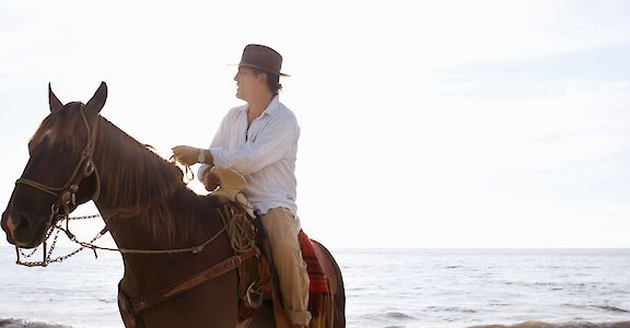 Sitting on a horse by the sea. Getty Images@Unsplash