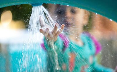 Child playing with water at a water park. Jeremiah Lawrence@Unsplash