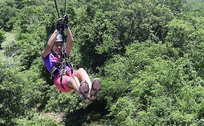 Child ziplining in the trees, Jamaica. CC:El Sol Vida