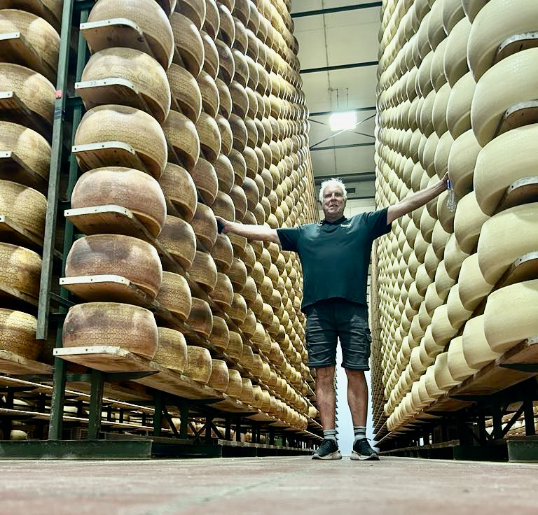 Raymond Lemoine standing by parmesan cheese Italy