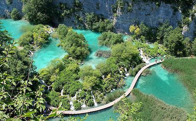 Drone shot of a boardwalk in Plitvice Lakes National Park, Croatia hiking tour. Unsplash@Pascal Habermann