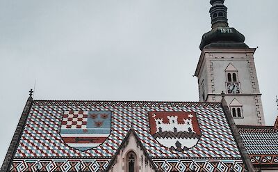 Historic church with patterned roof in Zagreb&rsquo;s old town. unsplash@David Boca