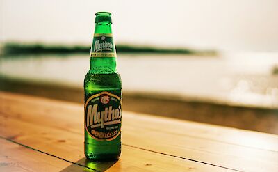 A refreshing Mythos beer after a day of cycling! unsplash:yannis papanastasopoulos