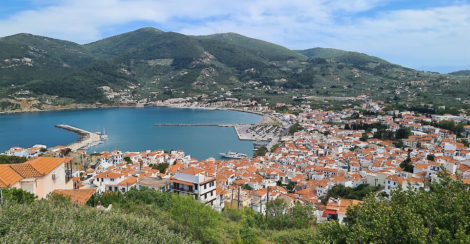 Skopelos Town is a hillside port with whitewashed houses, cobblestone streets, and stunning Aegean views. toIH