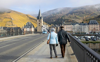 Couple walking over the bridge in Bernkastel-kues, Germany. Unsplash@Febe Vanermen